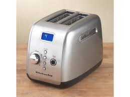 It features a large display on the front and displays the time of day. Kitchenaid Kmt223cu Contour Silver 2 Slice One Touch Motorized Lift Control Toaster Newegg Com