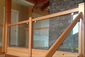 This incredibly cozy wood deck nestled in a pine forest above a crystal clear lake is perfect for glass balusters. Expert Glass Railings Interior Exterior Award Winning Service