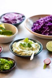 Drizzle a little liquid from the pickled cabbage over each taco and serve with the remaining lime wedges. Grilled Fish Tacos With Avocado Cilantro Sauce Kitchen Confidante