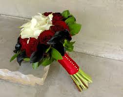 Red and white gerbera daisies and roses with a matching boutonniere. Red Roses And White Calla Lilies