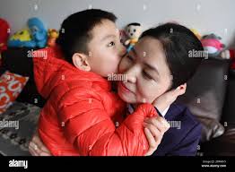 Mother kisses son hi-res stock photography and images