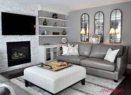White Ledgestone Fireplace Taupe Leather Sofa Upholstered Ottoman Arched Mirrors Family Room Built Family Room Mirror Decor Living Room Family Room Design
