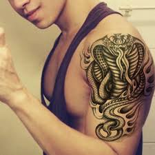 You can have a look negative space circle and flowers tattoo. King Cobra Tattoo Arm Elegant Arts Tattoo