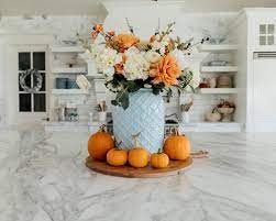 Simply insert the lemon or orange slices to the outside of a large vase, then slide a smaller glass vase in to hold the fruit in place. Diy Fall Centerpiece Blue And Orange Fall Centerpiece