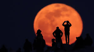 Can someone tell me, why, a week ago, at about 6.00pm or so the moon was huge really orange/yellow and near the horizon, then at midnight when i looked out my skylight it was really high in the sky, normal size and white. When To See The Snow Moon