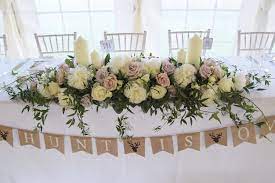 Find a wide range of wedding flowers and florists, ideas and pictures of the perfect wedding flowers at easy weddings. Long And Low Top Table Arrangement Wedding Table Flowers Wedding Top Table Flowers