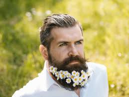 Handsome Man with Flowers in Beard Stock Photo