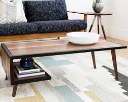 Characterized by its clean lines and open design, this understated coffee table brings a contemporary touch to your living room layout. Wood Steel Coffee Table Metal Frame Mid Century Modern Industrial Furniture Living Room Small Coffee Table Metal Frame Coffee Table Reclaimed Wood Coffee Table