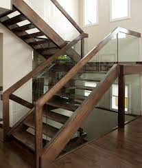 We Designed An Open Rise Maple Stair With Dadoed Glass Panel Railing The Stair Also Incorpo Stair Railing Design Wooden Staircase Railing Glass Railing Stairs