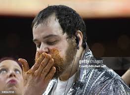 Patrick Bertoletti eats chicken wings during Wing Bowl 24