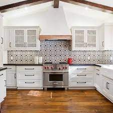 A rusted hood in the same the guest bath features dekton countertops on hemlock cabinets that mimic the wood grain and. Spanish Colonial Style Kitchen Design Ideas