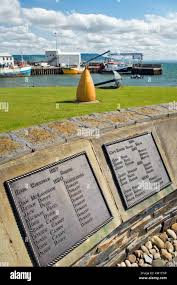 Memorial at Greencastle fishing harbour, Inishowen peninsula, County  Donegal, Ireland. Lists Inishowen sailors lost at sea Stock Photo