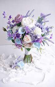Arrange with soft peach garden roses, silver dollar eucalyptus, and creamy white spray roses for a decadent look. Perfect Perfect Weddingengagementideas Purple Wedding Bouquets Flower Bouquet Wedding Wedding Flower Arrangements