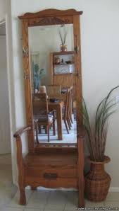 A hall tree or stand is a classic way to keep coats, hats, scarves, mittens, and umbrellas organized and both hall trees and coat racks can come in a variety of shapes and with many different features, including benches, mirrors, and hooks. Hall Tree Storage Bench With Mirror Ideas On Foter