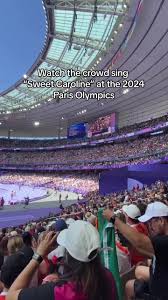 Fans at the 2024 Paris Olympics turned the track and field arena into  Fenway Park singing “Sweet Caroline.” #fyp #olympics #2024olympics  #sweetcaroline #fenwaypark