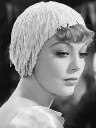 Actress, Loretta Young wearing a beautifully tailored striped suite and  Voilette hat from the film, Bedtime Story. Costume by Irene, 1941. Source.  IMDb