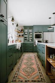 From hunter to olive, green is gaining popularity in every room in the house—but we can't get this space from devolkitchens features darker green cabinets paired with a grassier shade of green on the walls. A Gorgeous Kitchen With Dark Green Cabinets Black Hardware A Vintage Runner And Open Shelving Green Cabinets Interior Design Kitchen Home Decor Kitchen