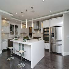 The black marble countertops pop against the traditional white cabinetry. China Foshan Factory Price Custom Modular Wood Cabinets Furniture Design Modern White Acrylic Sheets Board Kitchen Cabinet China Kitchen Cabinet Kitchen Cabinet Design