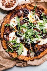 Make it their cauliflower pizza crust and you won't be sorry once you try it with shredded chicken, mozzarella cheese, and caramelized onions. Perfect Cauliflower Pizza Crust Recipe The Modern Proper