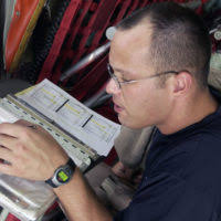 US Navy (USN) Electronics Technician Communications (ETN) Fireman (FN)  Ledan Sykes, maintains the closed circuit broadcasts television system  aboard the USN Aircraft Carrier, USS ENTERPRISE (CVN 65), as the ship is  conducting