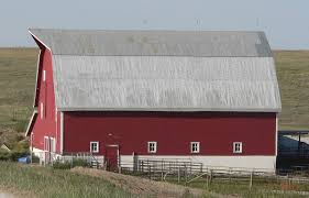 A view of a red cupola and weather vane on top of a barn on a sunny, cloudless summer day. Shafer Barn Wikipedia