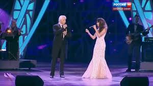 The stage lights dimmed, and in their place rose two voices that seemed  carved from memory itself — Dmitri Hvorostovsky's baritone, dark and velvet  with sorrow, and Aida Garifullina's soprano, shimmering like