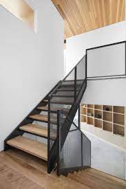 These Stairs Combine Wood Black Metal And Mesh To Create A Contemporary Look Staircase Design Modern Staircase Design Wood Railings For Stairs