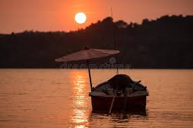 Free shipping on orders over $25 shipped by amazon. Fishing Boat With Umbrella At Sunset In The Sea Stock Photo Image Of Sand Orange 139816784