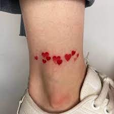 Female hand isolated with a love tattoo on her finger. 32 Tattoos That Symbolize Love 2021 Updated Saved Tattoo