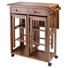 The dining table has four straight legs and a rectangular tabletop. 3pc Suzanne Space Saver Set Teak Winsome Target