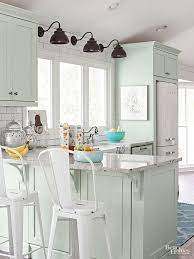 A modern light grey kitchen with a white tile backsplash made stand out with black grout. 10 Stunning Farmhouse Kitchens With Coloured Cabinets The Happy Housie