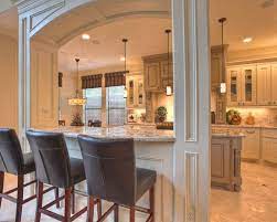 Viking range with a stainless steel backsplash and a wall mount polished nickel pot filler in a transitional kitchen. Kitchen Pass Through Kitchen Design Kitchen Columns Traditional Kitchen