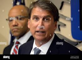 North Carolina Gov. Pat McCrory, left, stops to talk with Kelly Henninger  and Jeremiah Aponte, during his second shot from the 16th fairway during  the Wells Fargo Championship Pro-Am at Quail Hollow