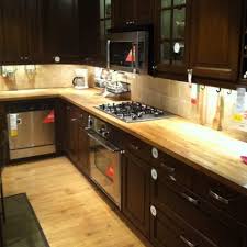 What follows are beautiful photos of kitchens with wood counters, along with design ideas we thought may be of interest to you. New Light Wood Floors Dark Cabinets Butcher Blocks Ideas Dark Brown Kitchen Cabinets Brown Kitchens Trendy Kitchen Backsplash