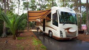 Campsites At Disney S Fort Wilderness Resort An Rv With Awning Parked On A Cement Pad In Wilderness Resort Disney Fort Wilderness Resort Fort Wilderness Disney