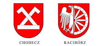 Herb przedstawia w polu czerwonym z heraldycznie prawej połuorła srebrnego, z lewej połukoło wozowe z pięcioma pełnymi szprychami, dzwonami i gwoździami. Runda 110 Kujawsko Pomorskie Zmierzy Sie Ze Fuczaq Wykop Pl