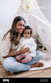 Happy Smiling Young Indian Mother Playing With Black Baby Girl Daughter Family Mixed Race People Mom And Kid Together Hugging At Home Authentic Cand Stock Photo Alamy