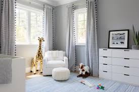 Zillow digs ™ patterned draperies complement the deep blue area rug in this beige nursery with wingback armchair and gray crib placed against the cloud accent wall. 34 Stylish Gender Neutral Nursery Ideas Hgtv