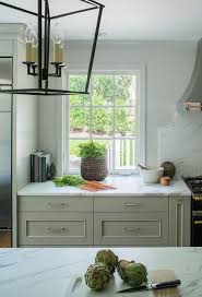 White And Gray Kitchen Features Light Gray Cabinets Paired With Calacatta Marble Countertops Kitchen Renovation Kitchen Remodel Kitchen Remodel Design