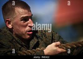 U.S. Marine Staff Sgt. Phillip Sandifer, a Marine Air Traffic Control  Mobile Team Leader from the Marine Air Control Squadron 1, shows his team  how to quickly set up a VS-17 panel