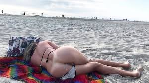 MILF was dozing on the beach when a stranger suddenly inserted his dick in  her ass - XNXX.COM
