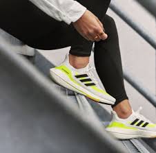 The only bits of color that disrupt the shoe's whiteout conditions are found on the ultra boos The Adidas Ultraboost 21 Is A Reliable Partner For Long Slow Runs