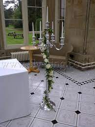 This candle holder can be ideal for almost any type of event or wedding ceremony. Silver Floor Standing Candelabra With Flower Garland By Lily King Weddings Candelabra Wedding Candelabra Wedding Ceremony Winter Wedding Decorations