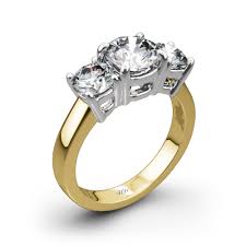 Halo engagement ring settings typically include a larger center stone encircled by a pavé or micropavé of smaller, accent stones. 3 Stone Diamond Engagement Ring 542