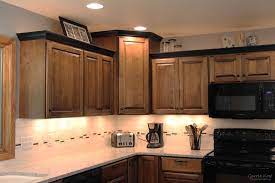 Contrasting Black Crown Molding On The Custom Cabinetry Coordinates With The Homeowners Crown Molding Kitchen Kitchen Cabinet Molding Complete Kitchen Remodel