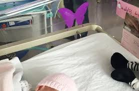 What does a purple butterfly sticker near a newborn mean?