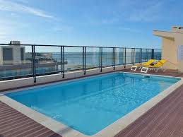 Swimming Pool Stunning Amazing Rooftop Pool Design Inspiration With Grey Plain Tiles Floor And Grey Mo Rooftop Pool Swimming Pool House Swimming Pool Designs