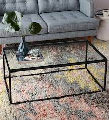 Each piece is made with a tubular steel frame in a black hue, and features crossbar stretchers for a striking and architectural look. Buy Coffee Table With Black Metal Frame Clear Glass Top By Asian Arts Online Contemporary Rectangular Coffee Tables Tables Furniture Pepperfry Product