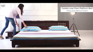 The bed frame benefits from the strong steel frame and legs. King Size Bed Carden Low Floor Platform Bed In Walnut Finish Wooden Street Youtube