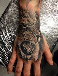 60 Eye Catching Tattoos On Hand Cuded Lion Hand Tattoo Lion Head Tattoos Tattoo Designs Men